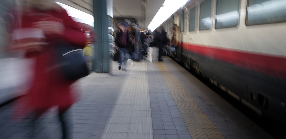 people out of focus at the train station